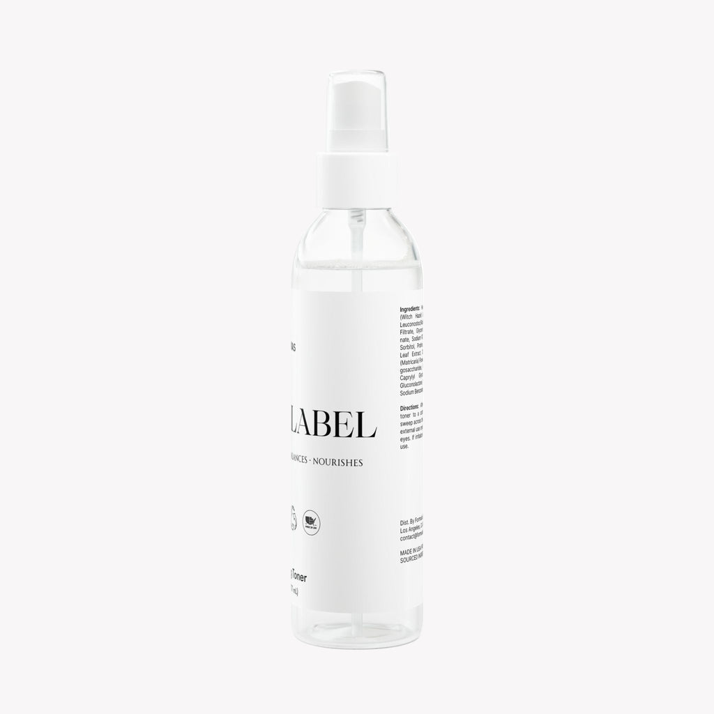 Clear spray bottle with a white label on a white background