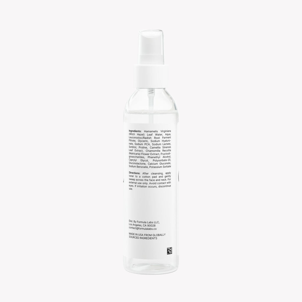 Clear spray bottle with label on a white background